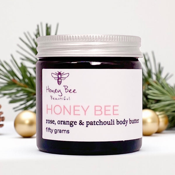 Rich raw honey and beeswax body butter in a glass jar — deeply nourishing treatment that melts into dry, sensitive or menopausal skin, leaving it smooth, supple and naturally radiant.