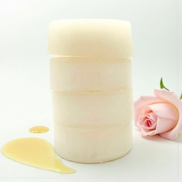 Stack of raw honey Queen Bee conditioner bar for normal, dry, or coloured hair - nourishes, softens, and strengthens hair, leaving it smooth, shiny, light, bouncy, and protected, ideal for daily use.