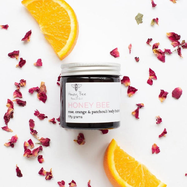Rich raw honey and beeswax body butter in a glass jar — deeply nourishing treatment that melts into dry, sensitive or menopausal skin, leaving it smooth, supple and naturally radiant.