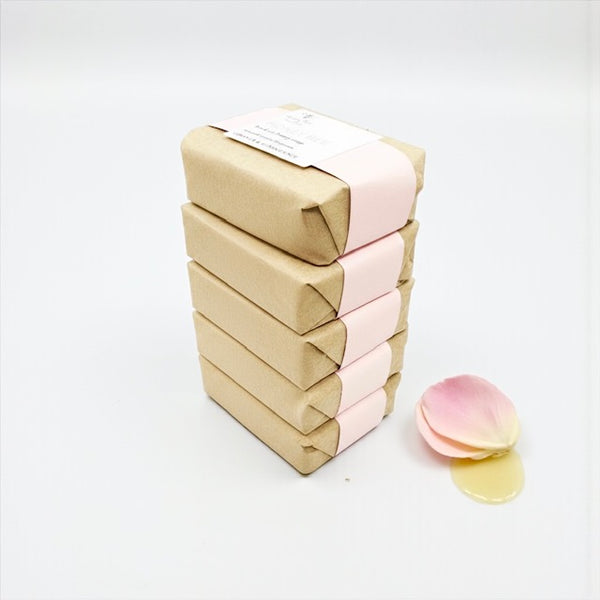 Stack of nourishing raw honey soap with geranium, frankincense, beeswax and plant oils, gentle, soothing formula for sensitive or peri-/menopausal skin with subtle floral-spicy aroma.