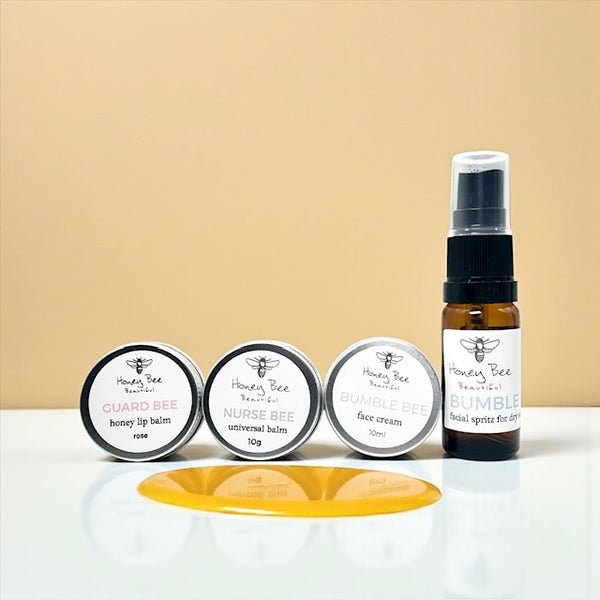 Mini gift set of raw honey skincare products including face cream, hand cream, and lip balm - especially formulated to nourish, protect, and soothe dry, sensitive menopausal skin, restoring moisture and comfort.